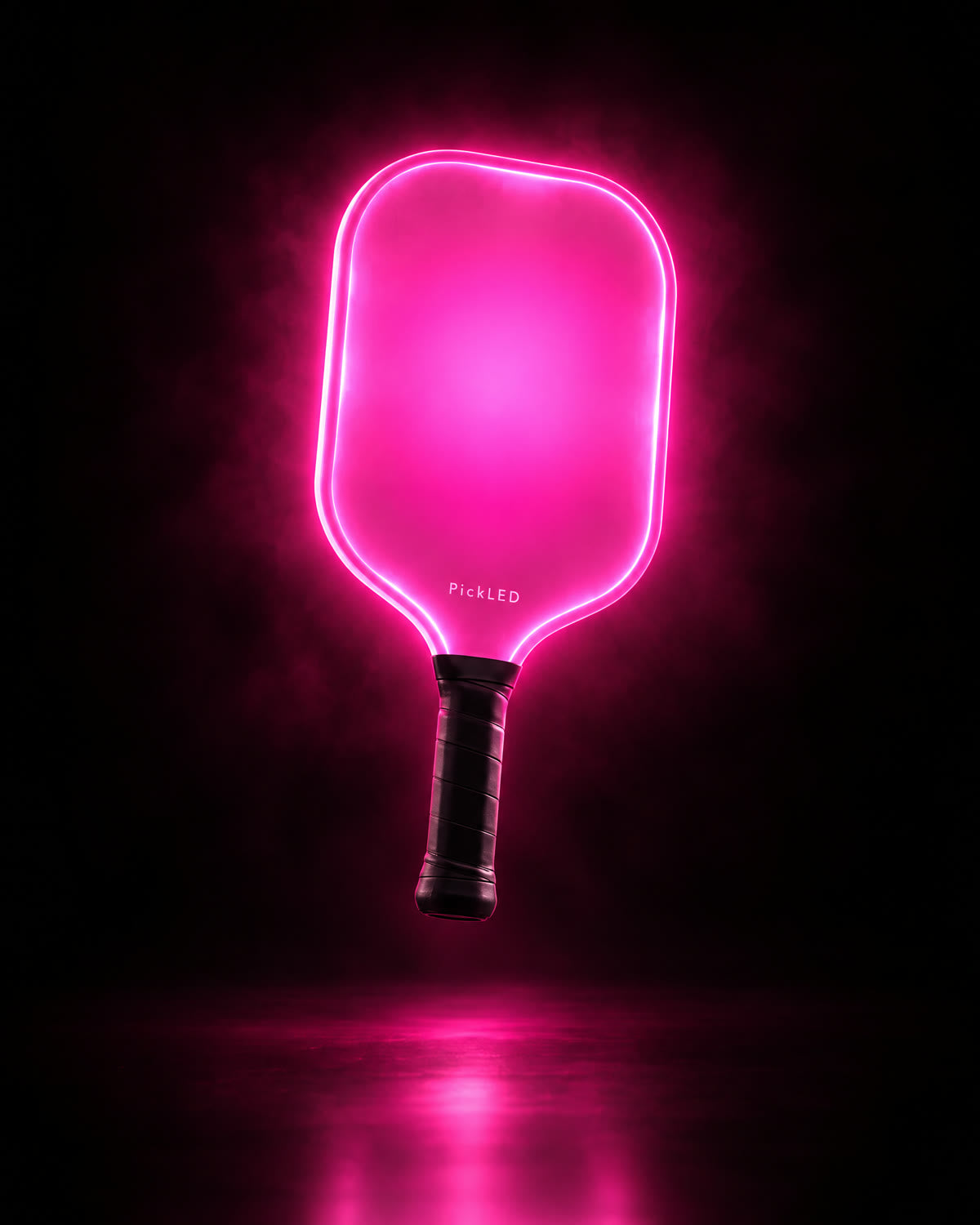 Pink PickLED paddle glowing in darkness